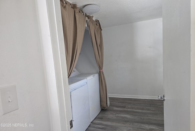 laundry room featuring laundry area, baseboards, wood finished floors, independent washer and dryer, and a textured ceiling