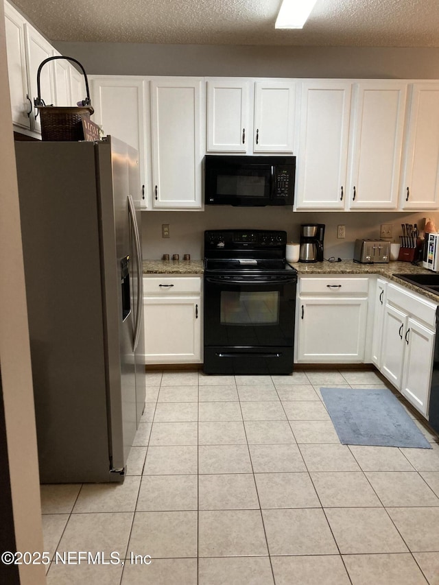 kitchen featuring a textured ceiling, black appliances, white cabinets, and light tile patterned flooring