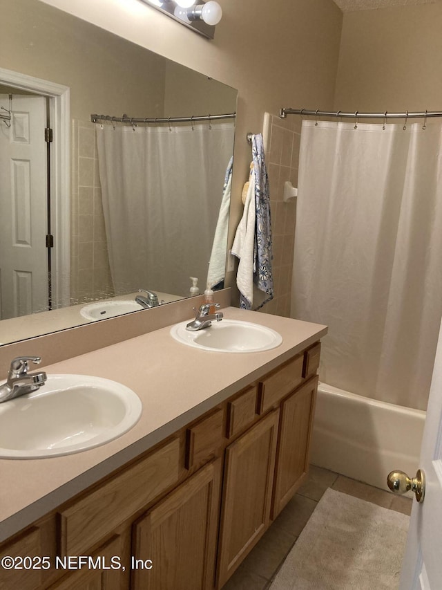 bathroom with a sink, double vanity, and tile patterned flooring