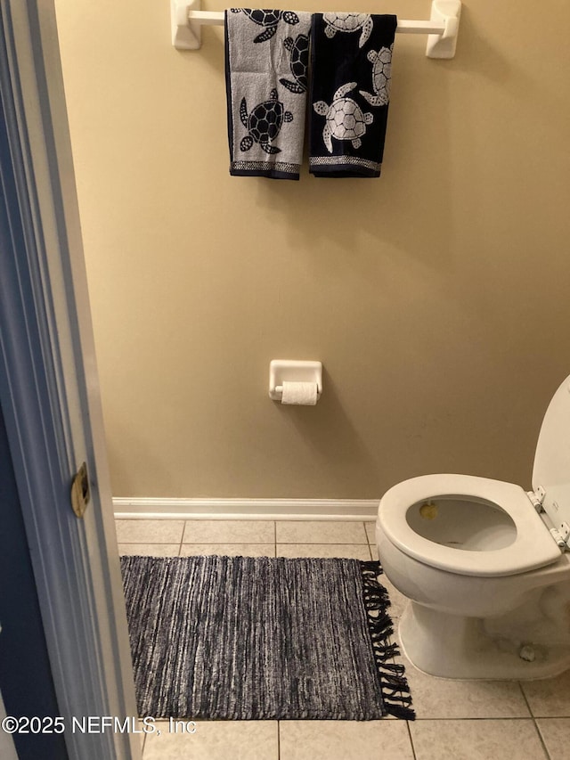 bathroom featuring tile patterned floors, toilet, and baseboards