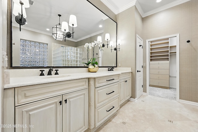 full bathroom featuring double vanity, ornamental molding, a walk in closet, and a sink