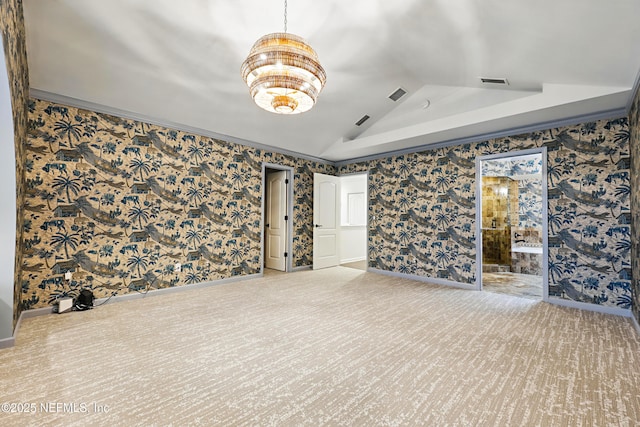 carpeted empty room with visible vents, vaulted ceiling, and wallpapered walls