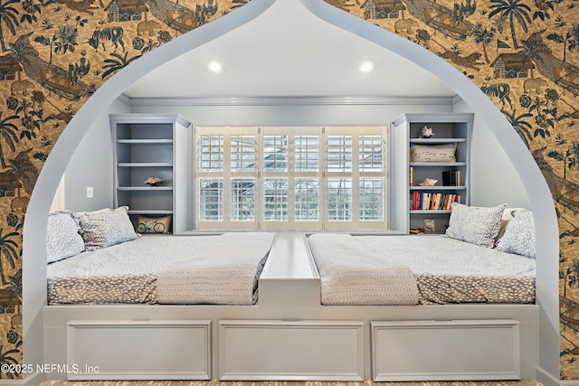 bedroom featuring crown molding, recessed lighting, and arched walkways