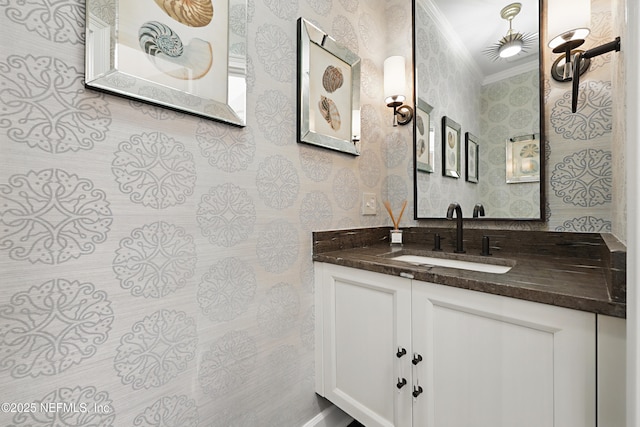 bathroom featuring wallpapered walls, vanity, and ornamental molding