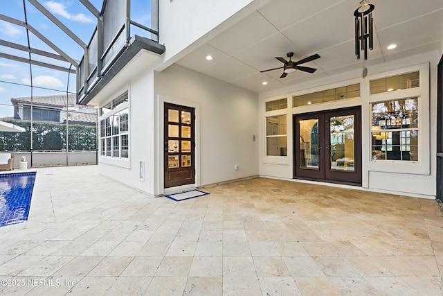 view of patio with a lanai, french doors, and ceiling fan