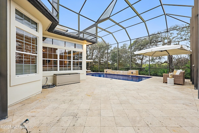 outdoor pool featuring glass enclosure and a patio area