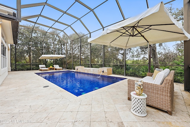 outdoor pool featuring a lanai and a patio area