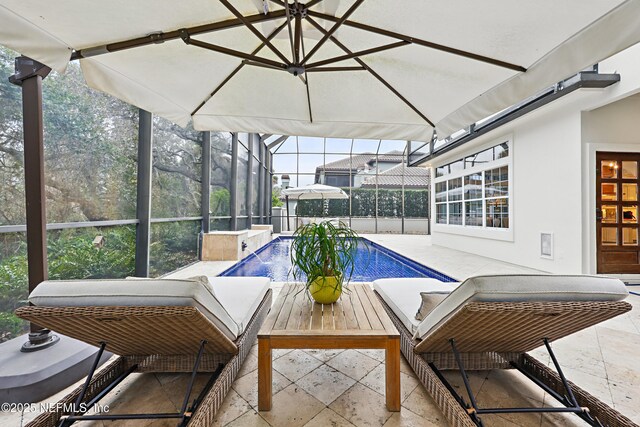 outdoor pool with a patio area and a lanai