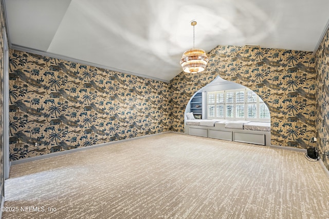 spare room featuring baseboards, vaulted ceiling, and wallpapered walls