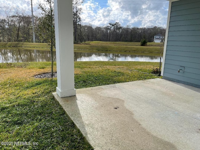 view of yard with a patio and a water view