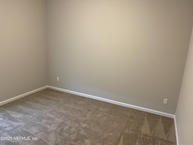 spare room with carpet flooring and baseboards