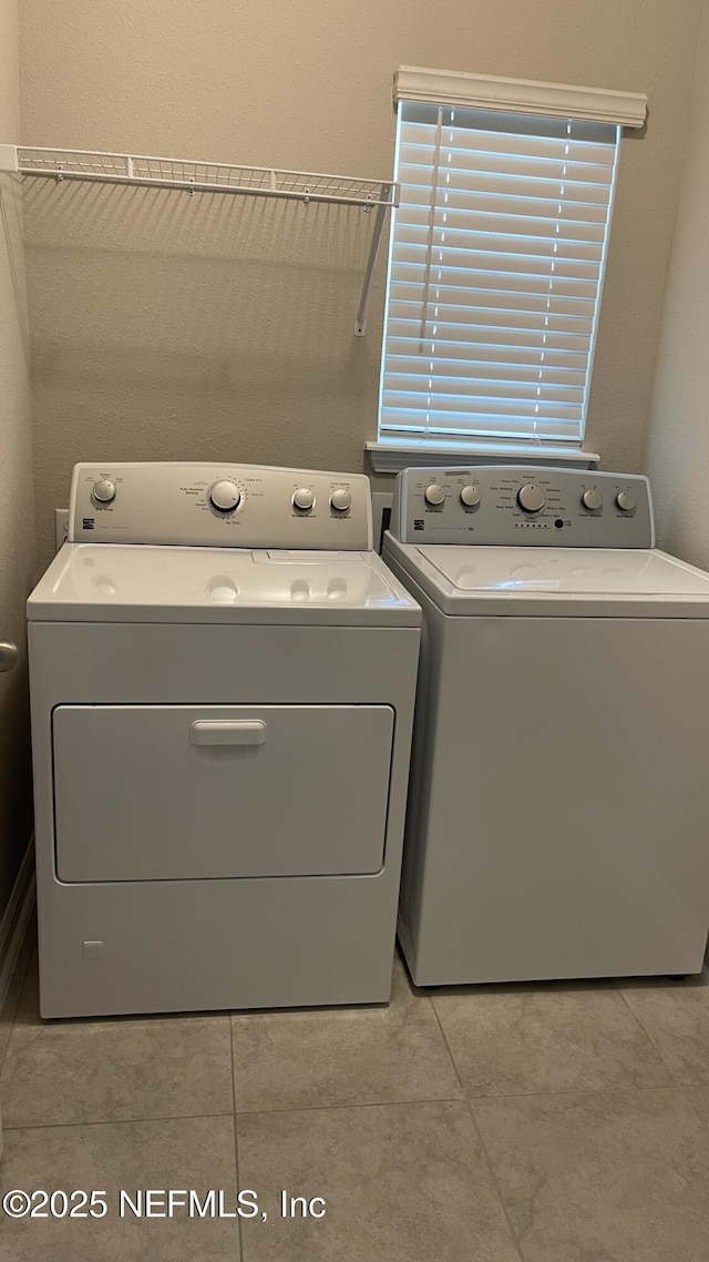 washroom featuring washing machine and clothes dryer and laundry area