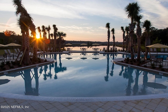 view of pool featuring a water view