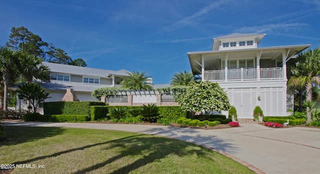 beach home featuring a front yard