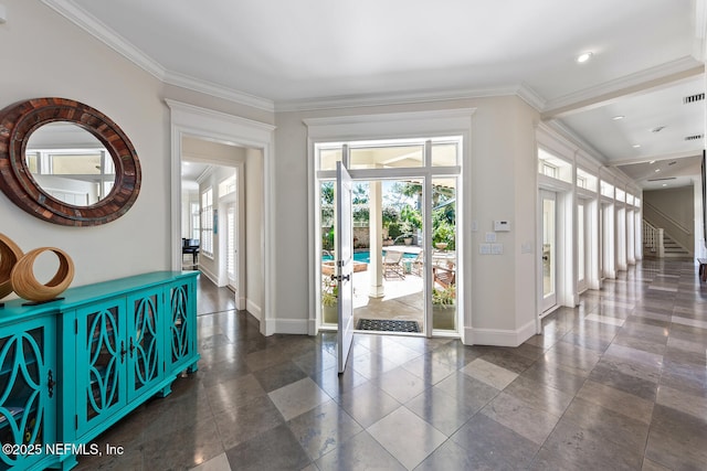 entryway with french doors, baseboards, and ornamental molding