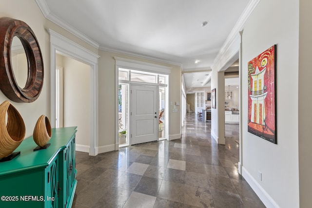 entryway with crown molding and baseboards