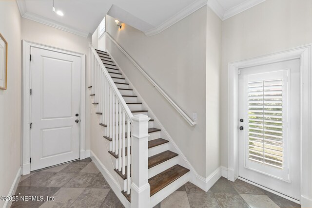 stairway with crown molding, baseboards, and stone finish flooring