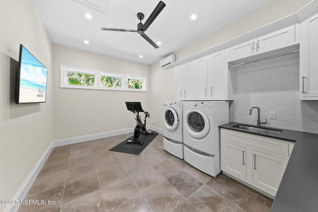 washroom with ceiling fan, washer and clothes dryer, recessed lighting, cabinet space, and a sink