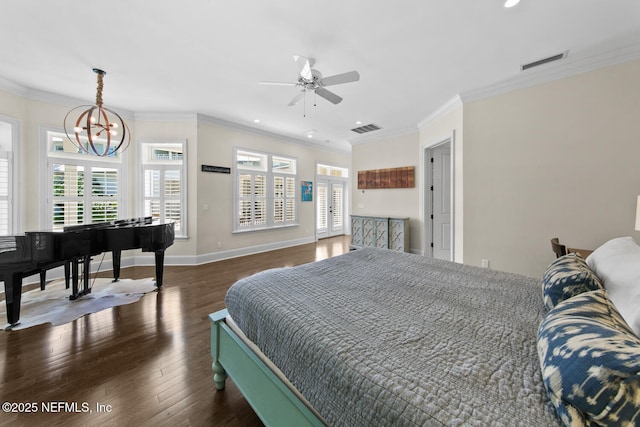 bedroom featuring wood finished floors, visible vents, a chandelier, and ornamental molding
