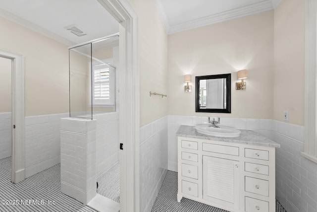bathroom featuring tile walls, walk in shower, and wainscoting