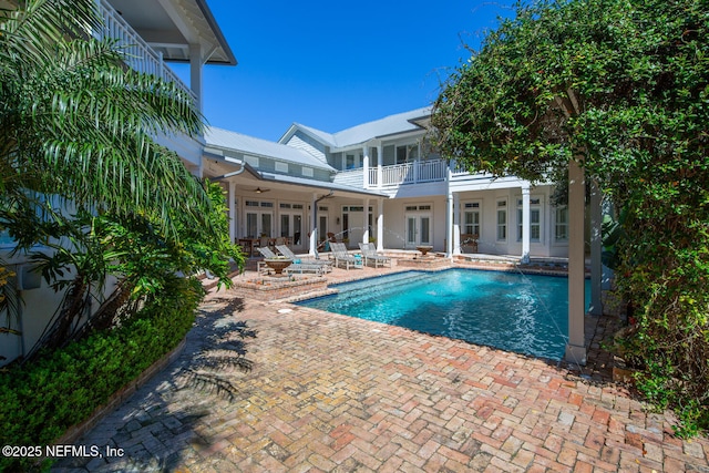 pool featuring a ceiling fan, a patio, and french doors