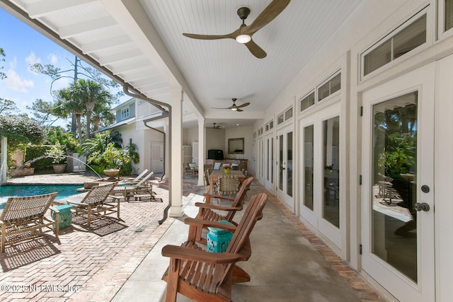 view of patio featuring an outdoor pool and ceiling fan