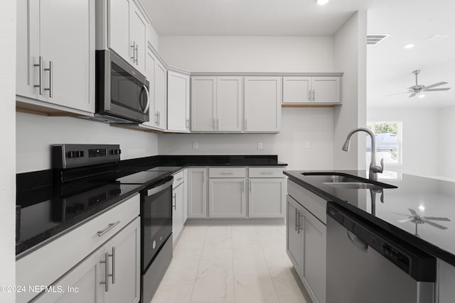 kitchen with visible vents, a ceiling fan, appliances with stainless steel finishes, marble finish floor, and a sink