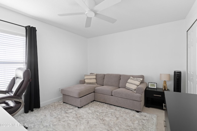 office area with baseboards, a ceiling fan, and carpet