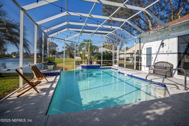 outdoor pool with glass enclosure and a patio area