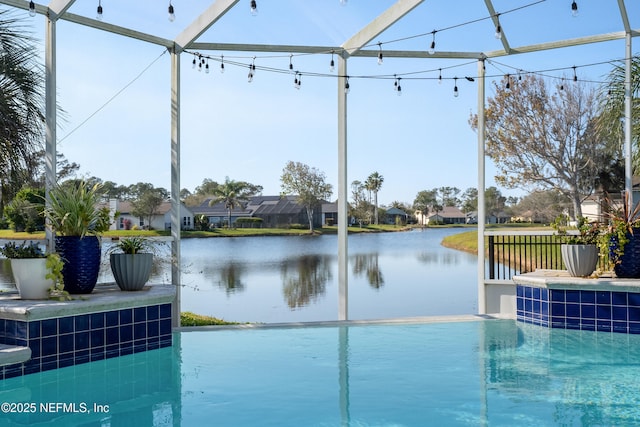 view of swimming pool featuring a water view