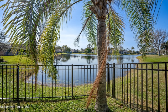 property view of water featuring fence