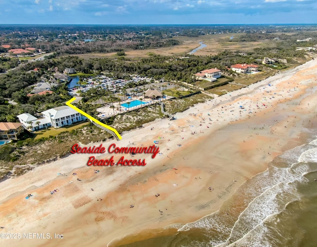 aerial view with a water view and a beach view