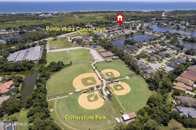 birds eye view of property featuring a water view and a residential view