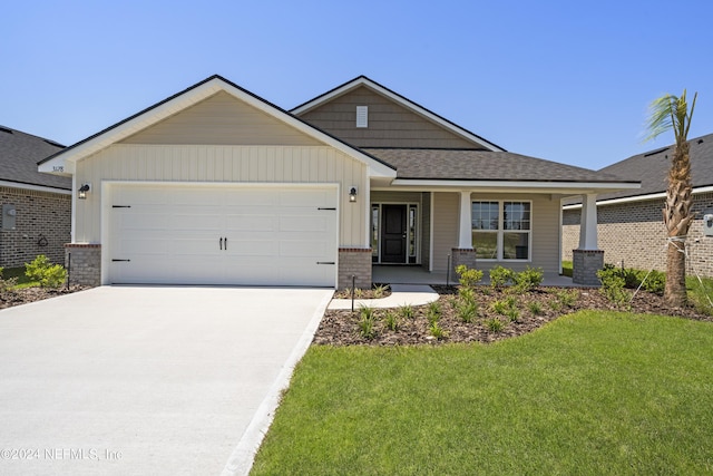 view of front facade with a front lawn, concrete driveway, a shingled roof, and an attached garage