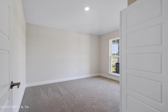 empty room featuring carpet floors, recessed lighting, and baseboards