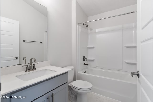 full bath featuring marble finish floor, tub / shower combination, vanity, and toilet