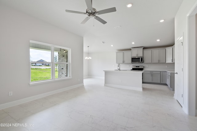 kitchen with marble finish floor, recessed lighting, gray cabinets, appliances with stainless steel finishes, and baseboards