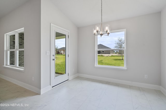 unfurnished dining area featuring marble finish floor, baseboards, and a chandelier