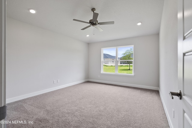 carpeted empty room featuring ceiling fan, baseboards, and recessed lighting