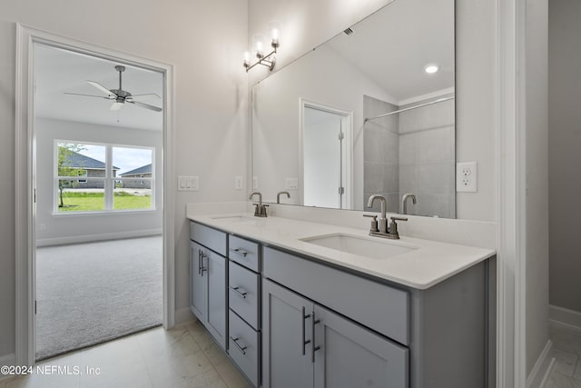 bathroom with ceiling fan, a sink, baseboards, and double vanity