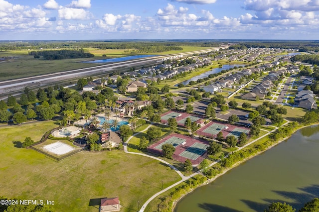 drone / aerial view with a water view and a residential view