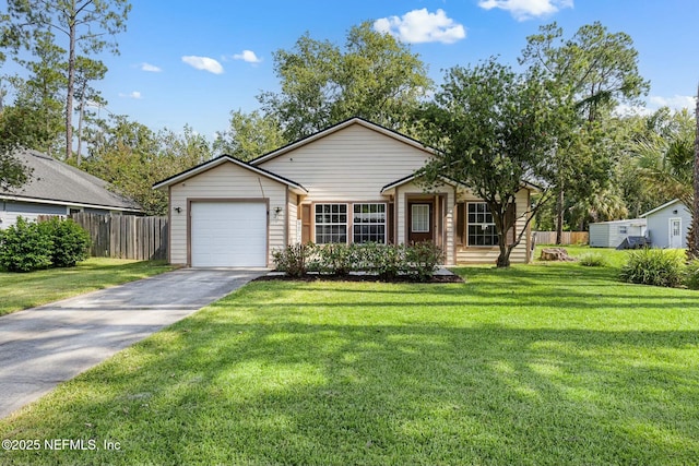 view of front of home featuring driveway, a front yard, an attached garage, and fence