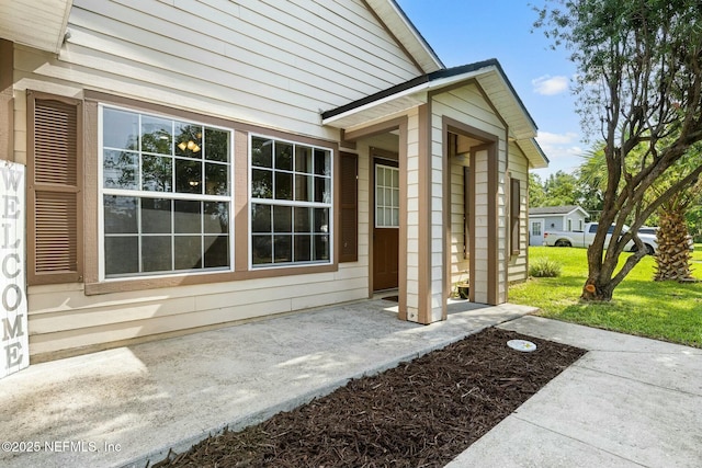 doorway to property with a yard