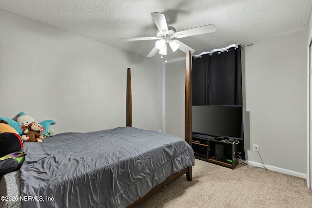 carpeted bedroom featuring baseboards, a textured ceiling, and ceiling fan