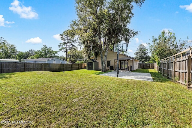 view of yard with a fenced backyard, a storage unit, an outdoor structure, and a patio