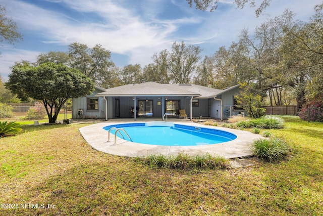 view of swimming pool with a yard, a patio area, a fenced in pool, and fence