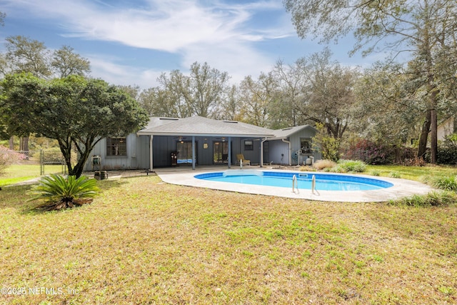 view of pool with a yard, a patio, a fenced in pool, and fence