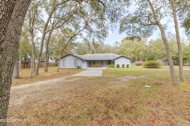 exterior space featuring concrete driveway and fence