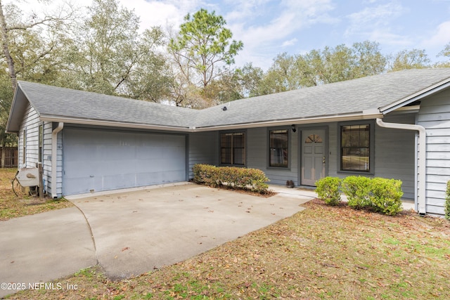 ranch-style house with driveway, a shingled roof, and a garage