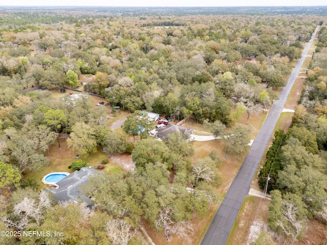 aerial view featuring a wooded view